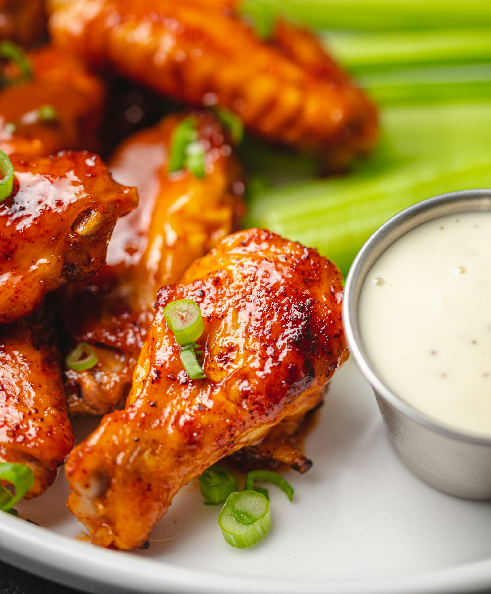 Chicken wings served with celery and a creamy dipping sauce
